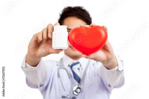 Asian male doctor with red heart and pill bottle © halfbottle