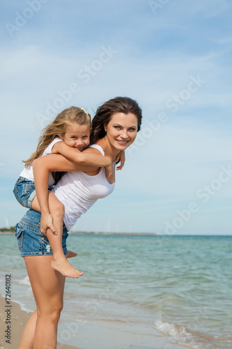 Mother and her daughter having fun on the beach