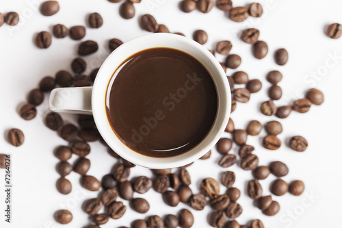 Coffee cup and beans on white