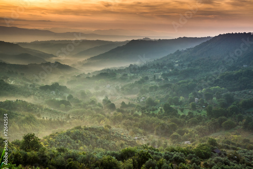 Fog at dawn over the valley in Tuscany