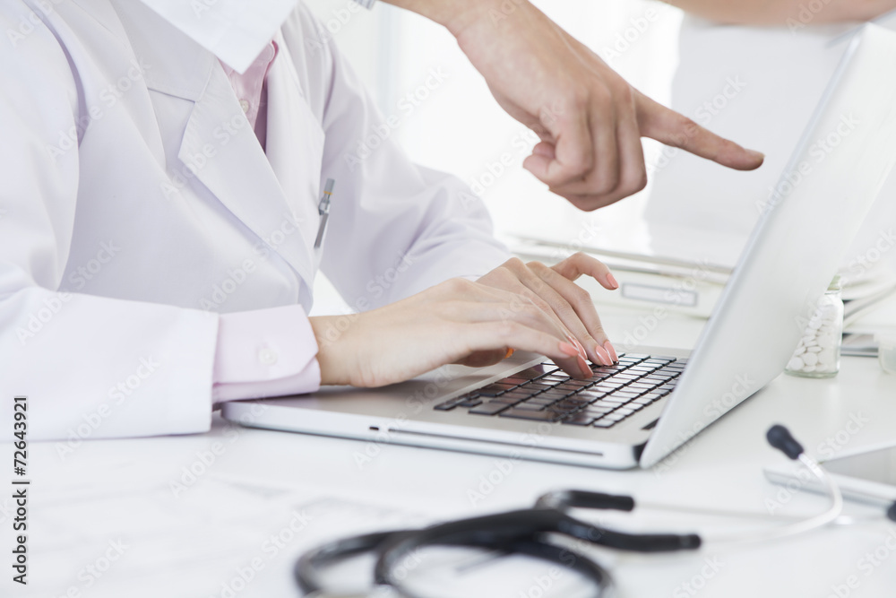 Doctor pointing to the finger to the PC Doctor pointing to the finger to the PC