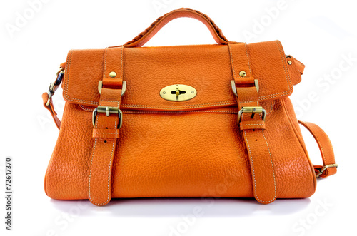 The orange lady handbag leather has a handle, a strap and a front pocket for opening isolated on white background shot in studio. clipping path in picture.
