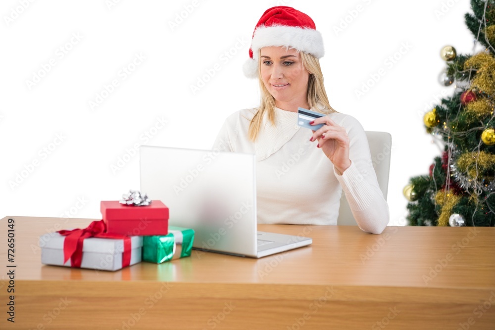 Festive blonde shopping online with laptop Festive blonde shopping online with laptop