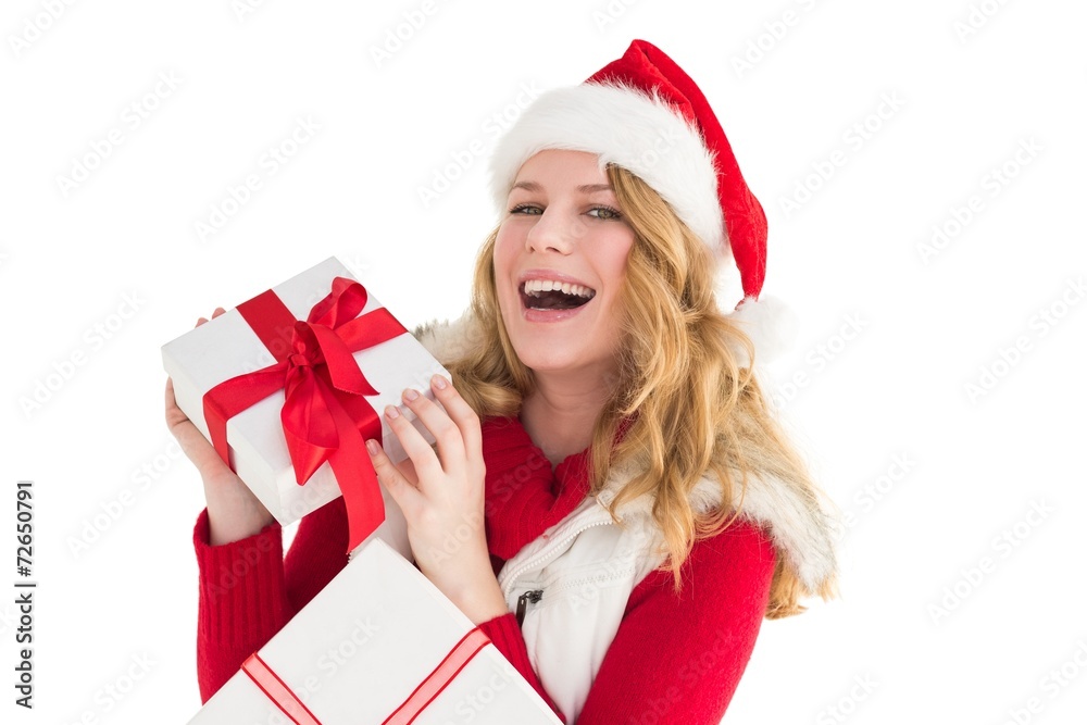 Happy woman in santa hat holding a gift Happy woman in santa hat holding a gift