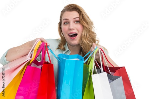 Overwhelmed young woman with shopping bags