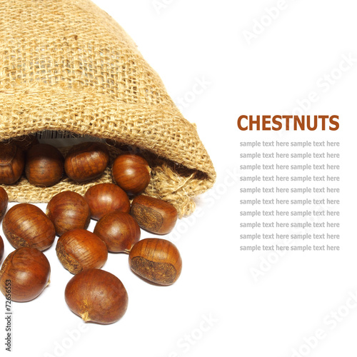 Fresh Chestnuts in yute isolated on white photo