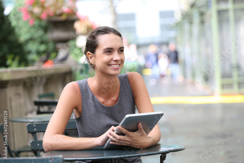 Free Download Businesswoman working on digital tablet in park - GFXLoad