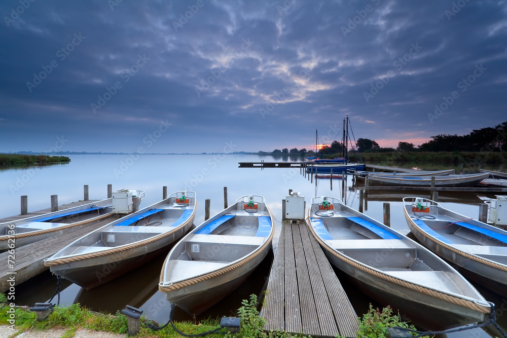 Fototapeta premium boats on lake harbor at sunrise