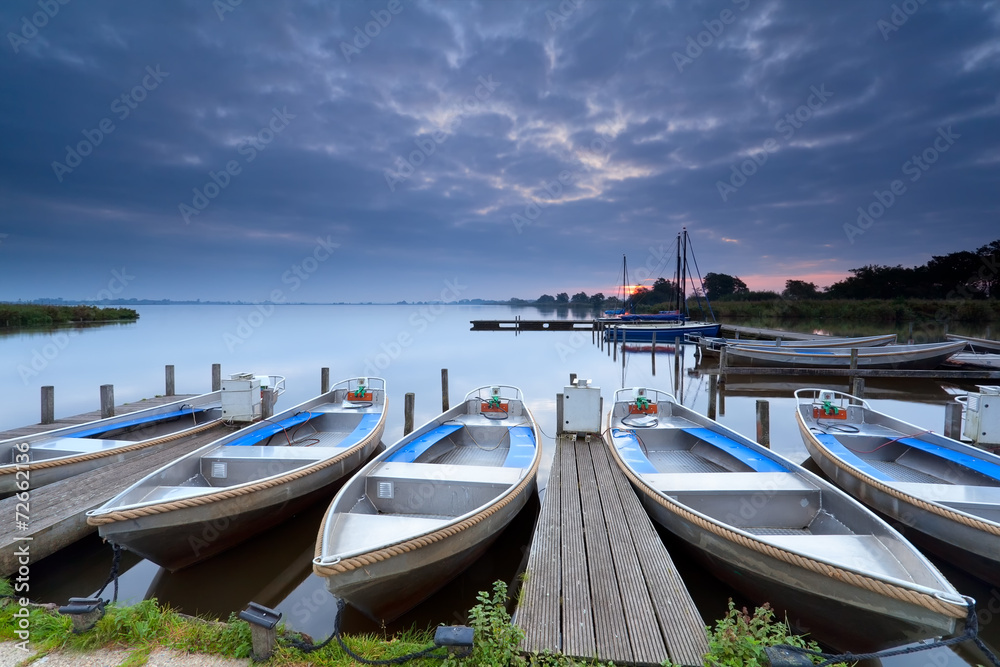 boats on lake harbor at sunrise