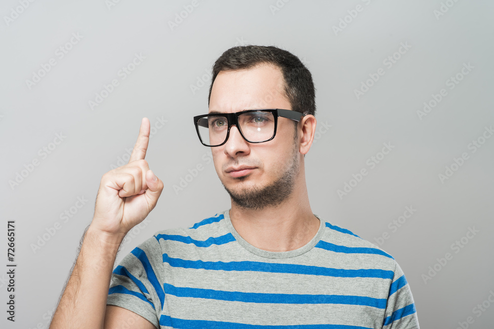 Closeup portrait of young business man pointing up having idea