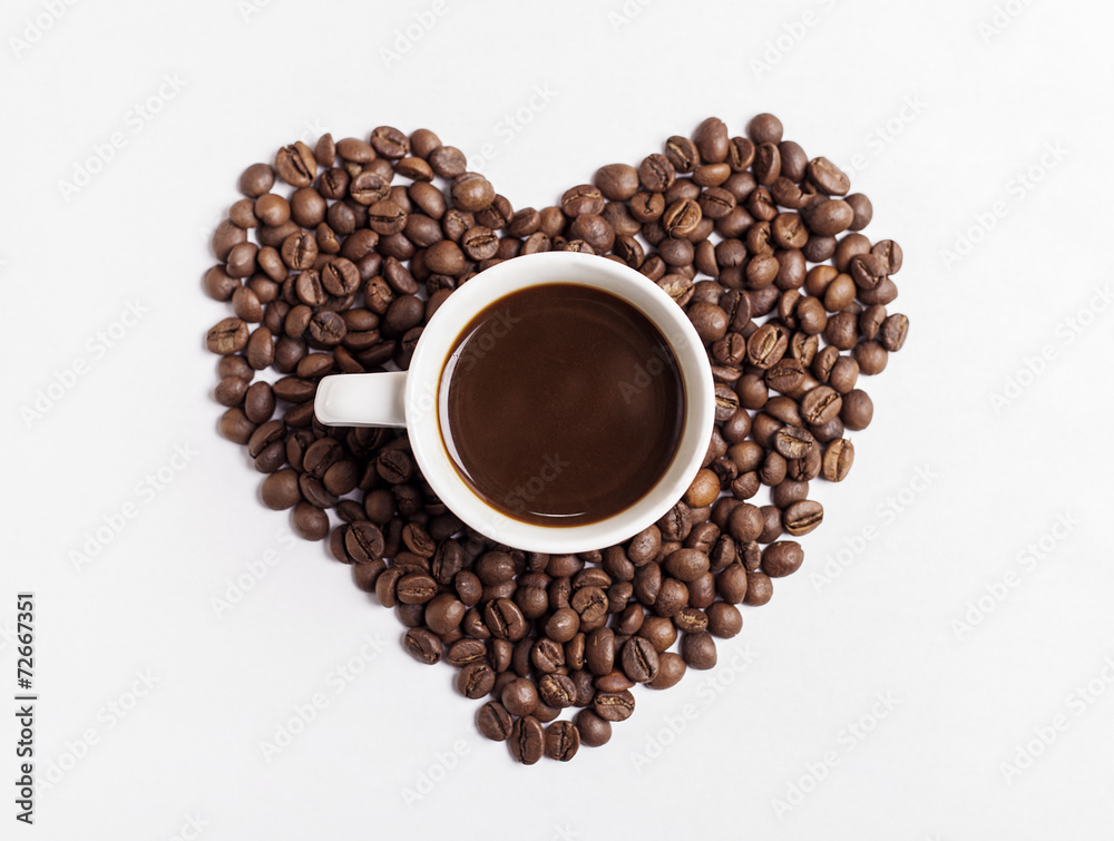 Fototapeta premium Coffee cup and heart-shaped coffee beans