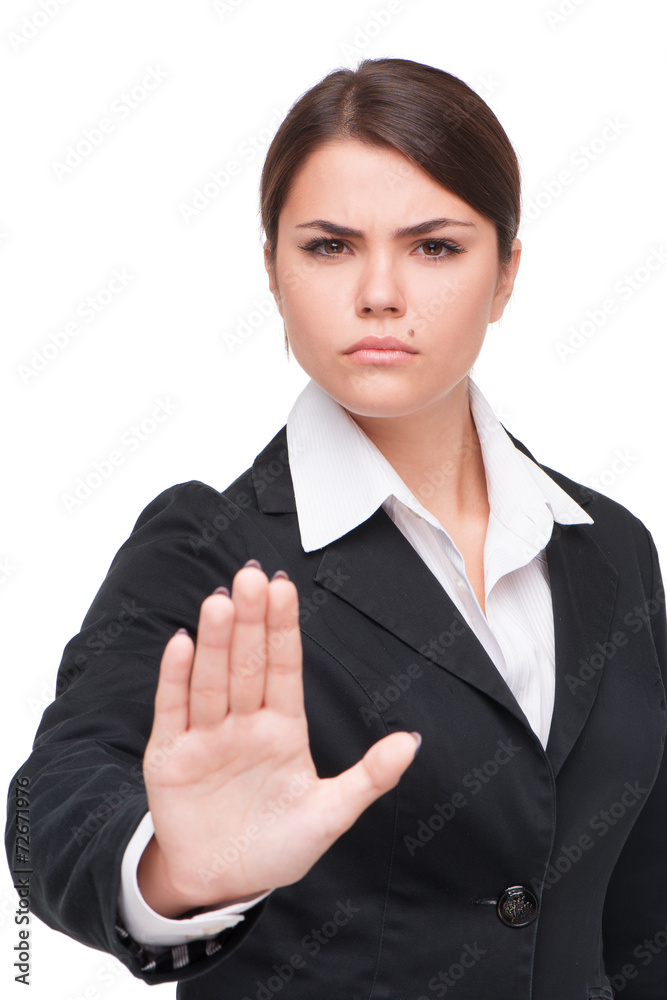 Serious young business woman doing stop gesture Serious young business woman doing stop gesture
