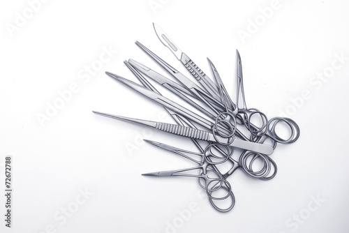 Numerous surgical instruments on a white background photo