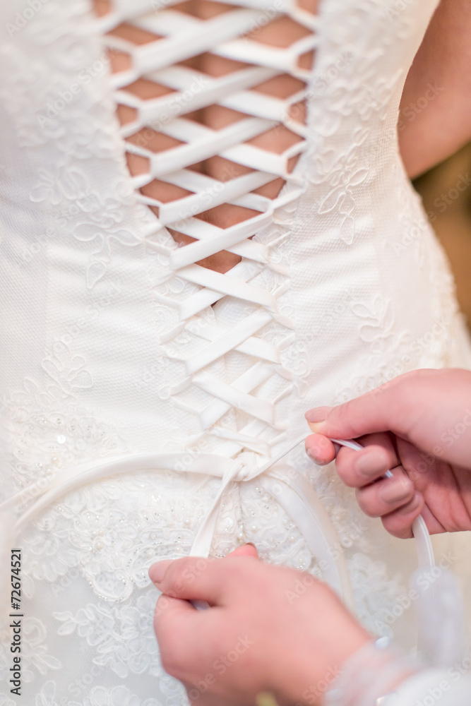 bridesmaid tying knot on wedding dress bridesmaid tying knot on wedding dress