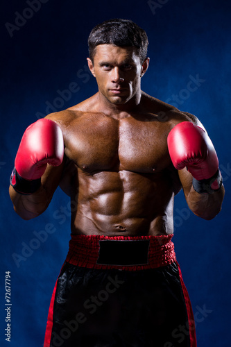 Boxer Boxing staring showing strength. Young man looking aggress © kanzefar