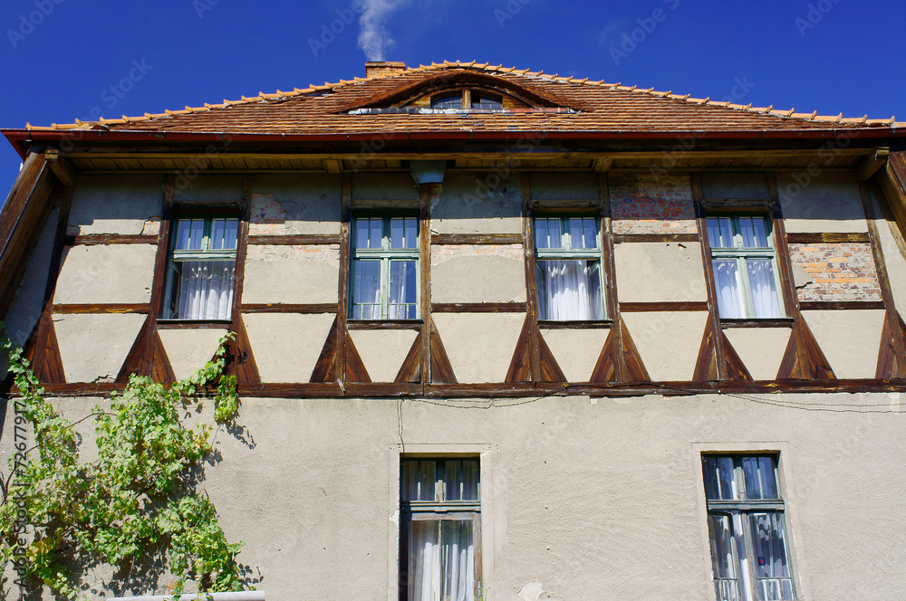 Ox-eye in the wall of a half-timbered building in Poland . Ox-eye in the wall of a half-timbered building in Poland .