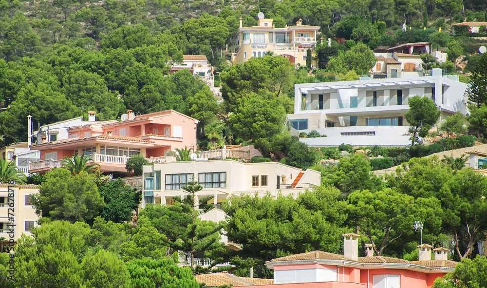 Fototapeta premium Houses in the green mountain hills.