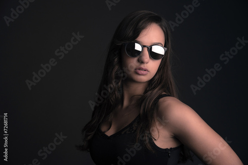 Fashion teenage brunette girl wearing sunglasses. Long brown hai