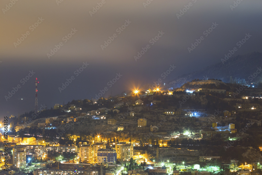 City under mountain at night