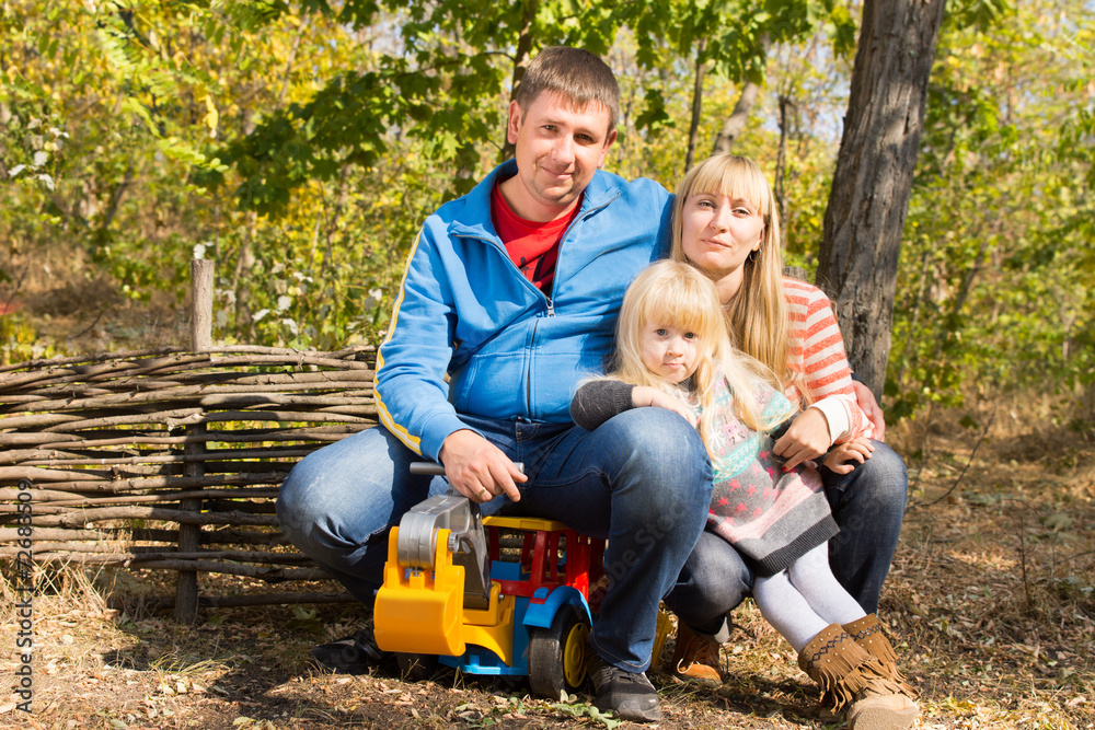 Happy young family outdoors in woodland