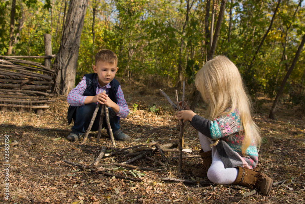 Creative young boy and girl playing with branches