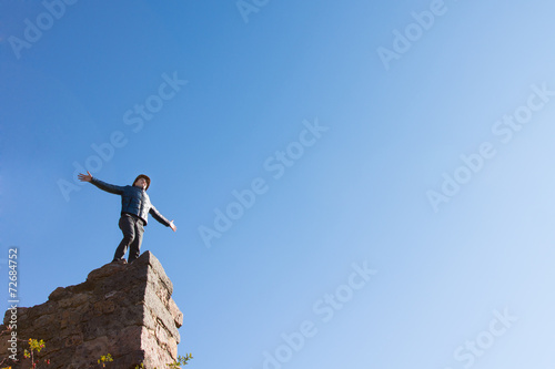 Young man celebrating on a ruined building