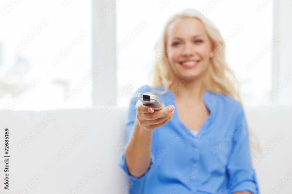 smiling teenage girl with tv remote control smiling teenage girl with tv remote control