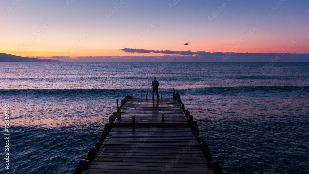 Black sea at dawn with pier
