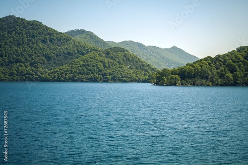 Turquoise sea and green mountain © avirid