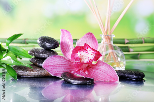 Spa stones  sticks  bamboo branches and lilac orchid