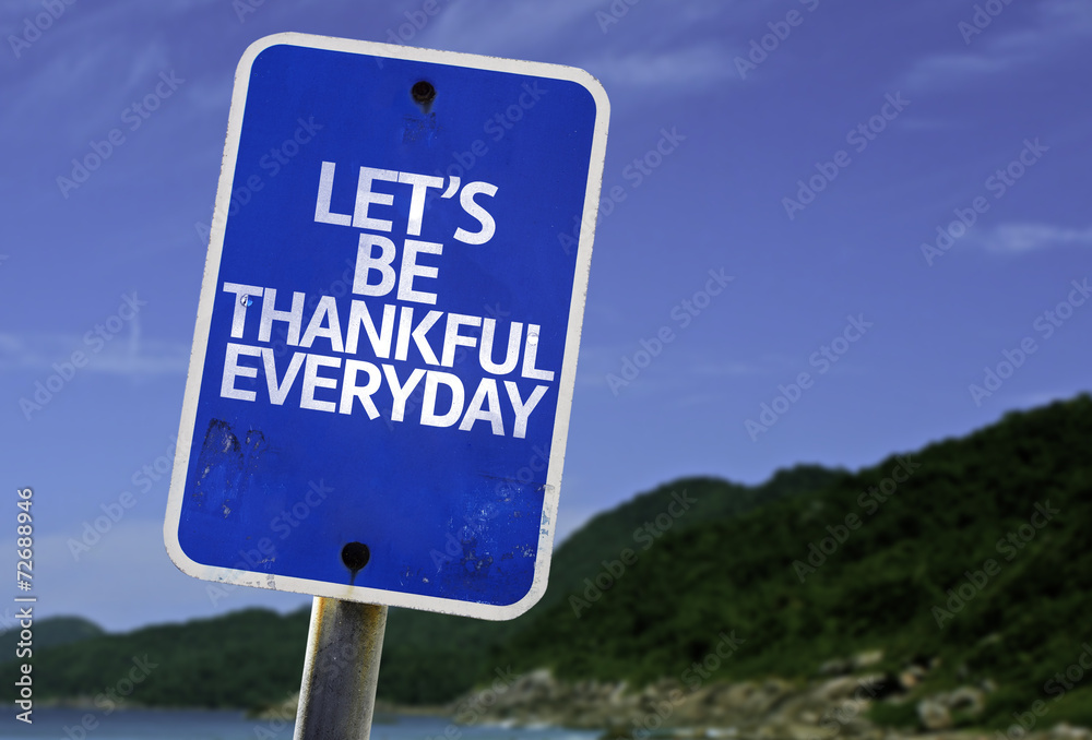 Let's Be Thankful Everyday sign with a beach on background