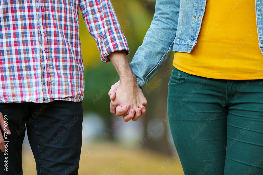 Loving couple holding hands outdoors