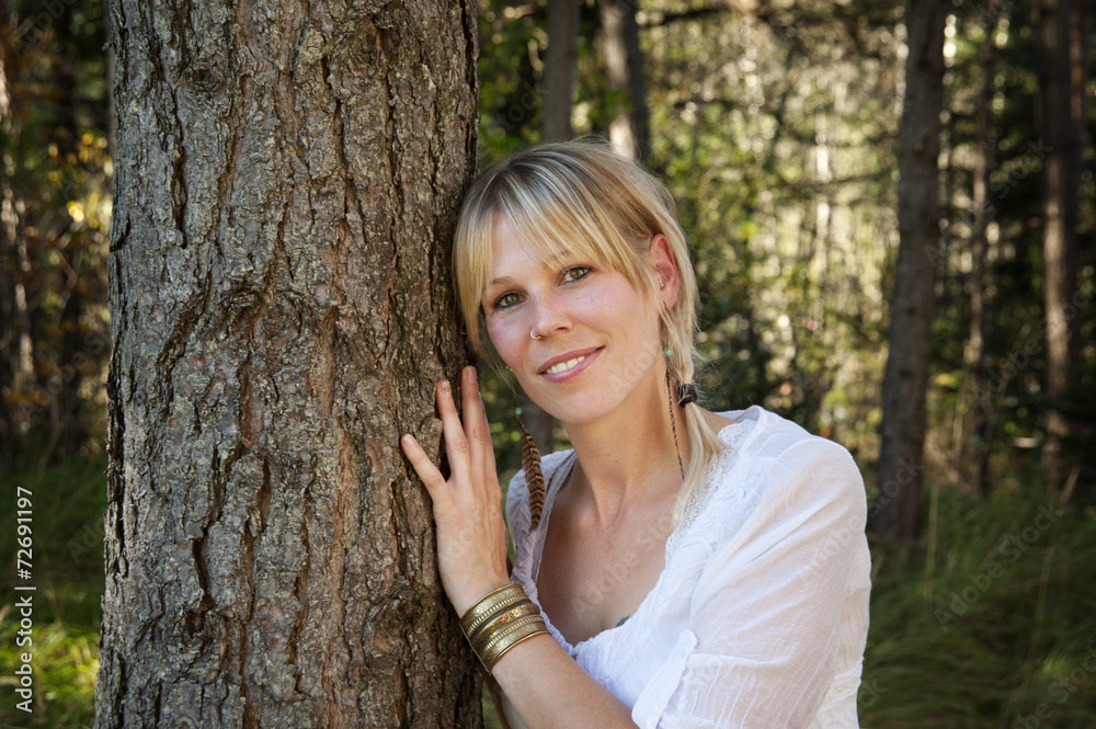 Environmental Portrait of a woman hugging a tree in a forest