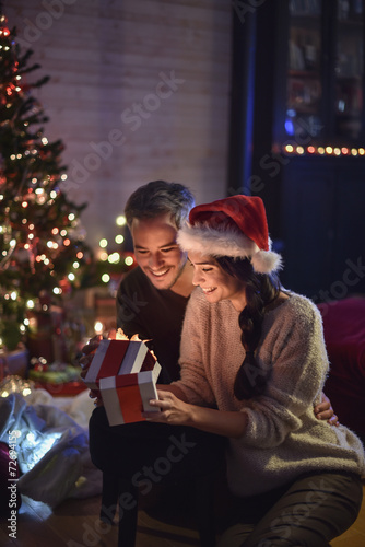 portrait of a young couple in their living room in christmas ev