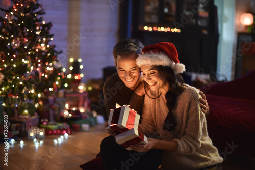 portrait of a young couple in their living room at christmas eve