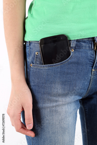 Smart phone in pocket jeans close-up