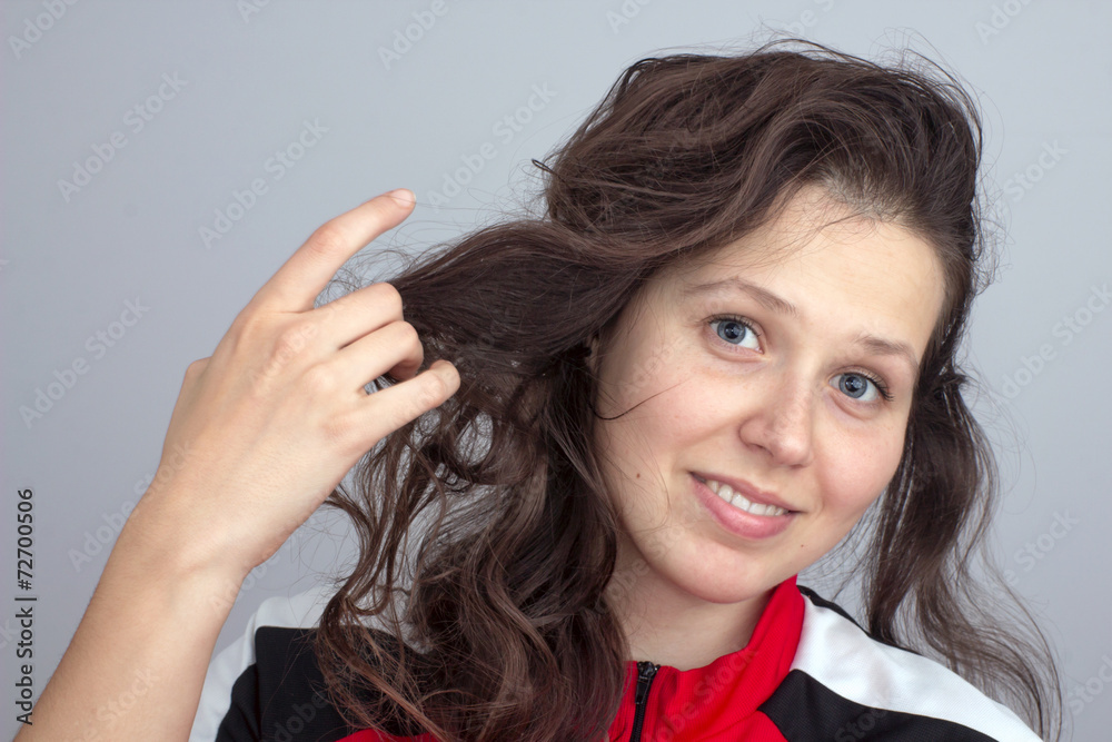 Smiling girl's face and hand tousling hair Smiling girl's face and hand tousling hair