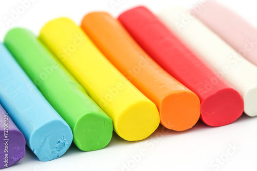 Colorful rod plasticine arranging on white background