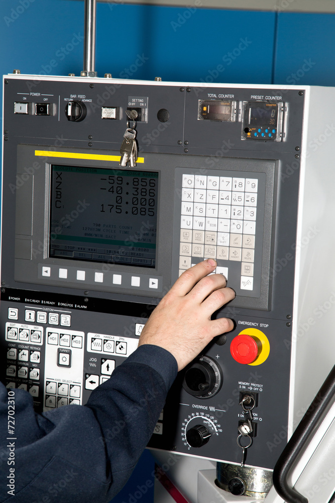 Man hand the controls of a machine CNC