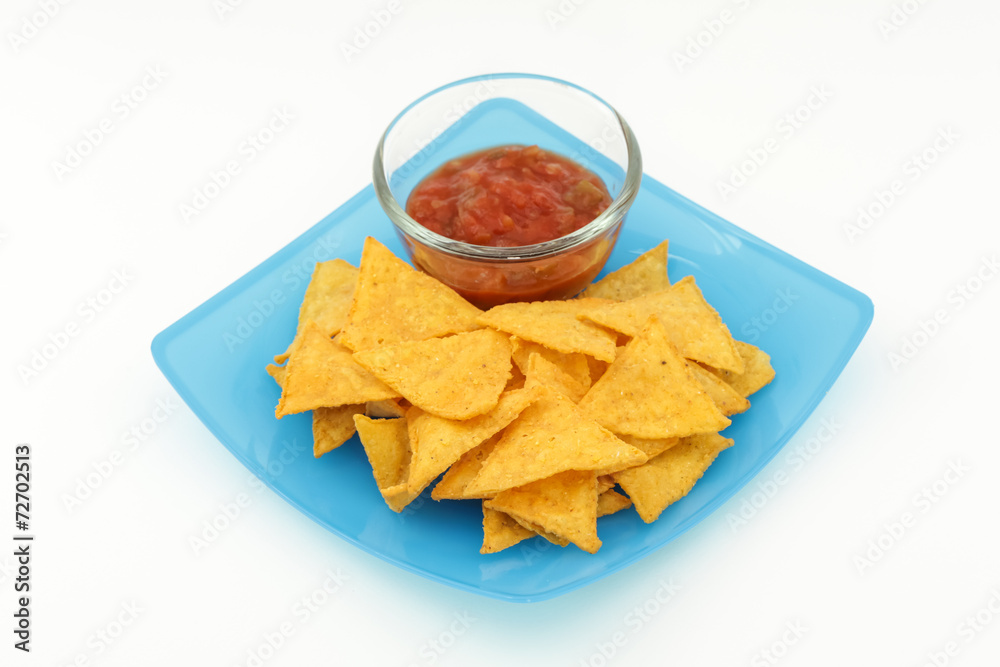 Tortilla chips with salsa sauce in dish on white background Tortilla chips with salsa sauce in dish on white background