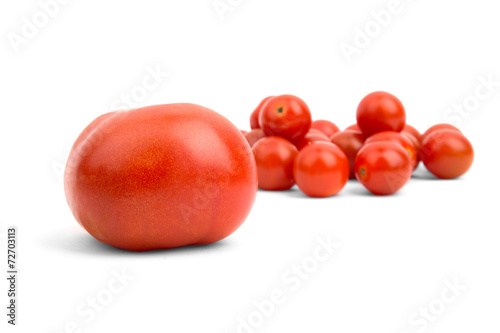 Big tomato on the background of small cherry