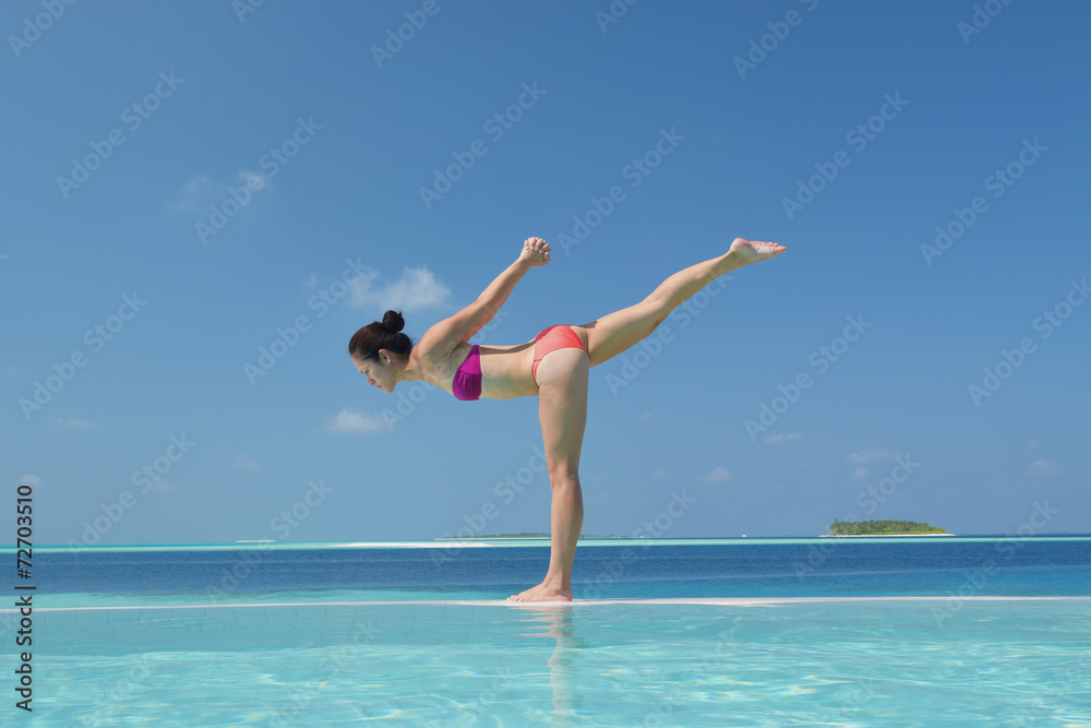 Asian chinese woman practising yoga by the sea Asian chinese woman practising yoga by the sea