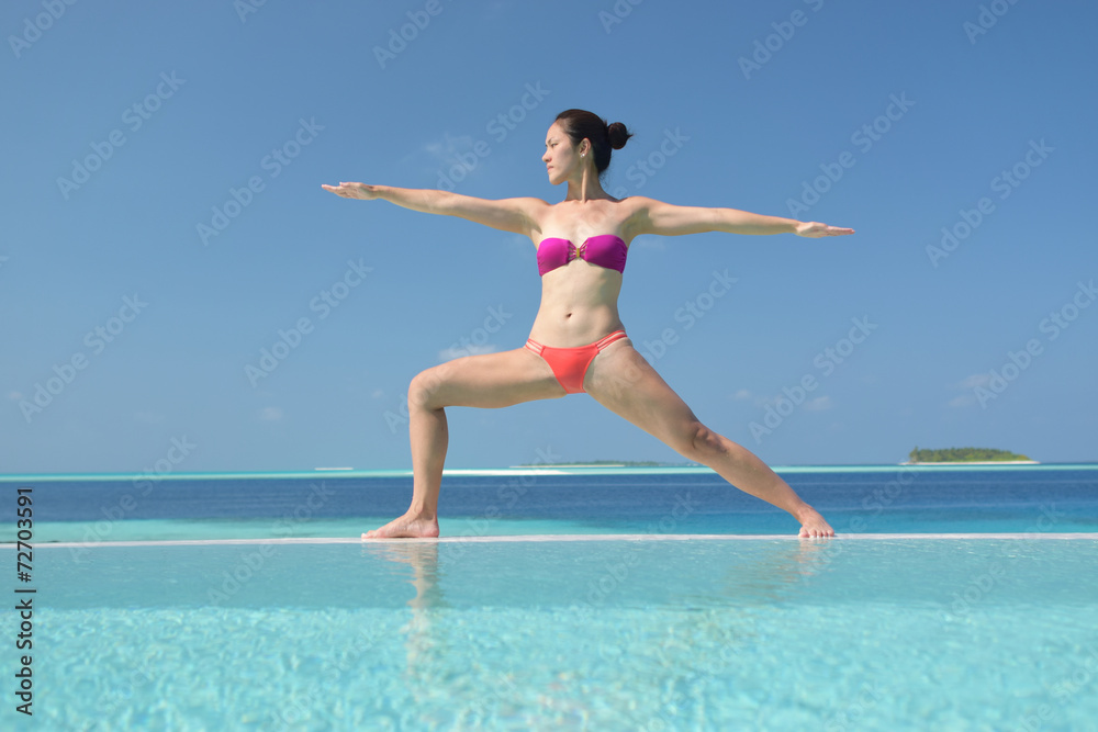 Asian chinese woman practising yoga by the sea Asian chinese woman practising yoga by the sea
