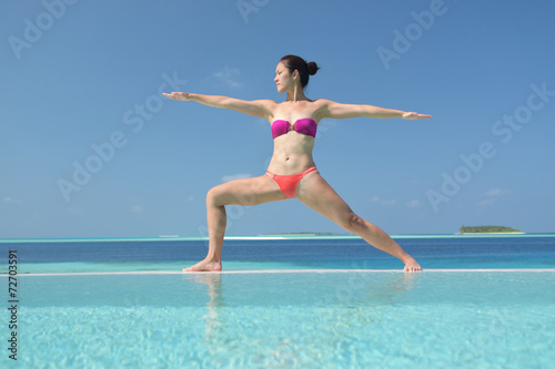 Asian chinese woman practising yoga by the sea © 1000words