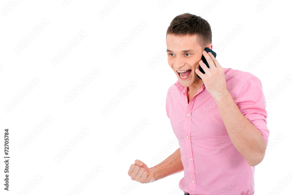 A man talking on the phone expressing a success. A man talking on the phone expressing a success.
