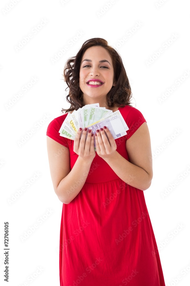 Stylish brunette in red dress holding cash Stylish brunette in red dress holding cash