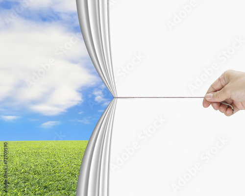 hand pulling open white blank curtain discovered natural sky mea