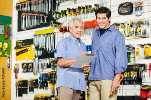 Father And Son With Clipboard In Hardware Store