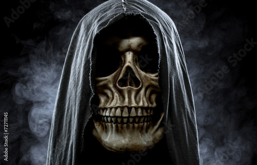 Grim reaper, portrait of a skull in the hood over black, foggy b