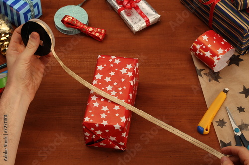 Wrapping Christmas gift - golden ribbon